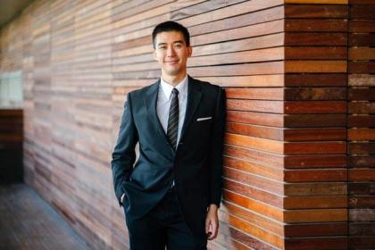 a man in a suit near the wall